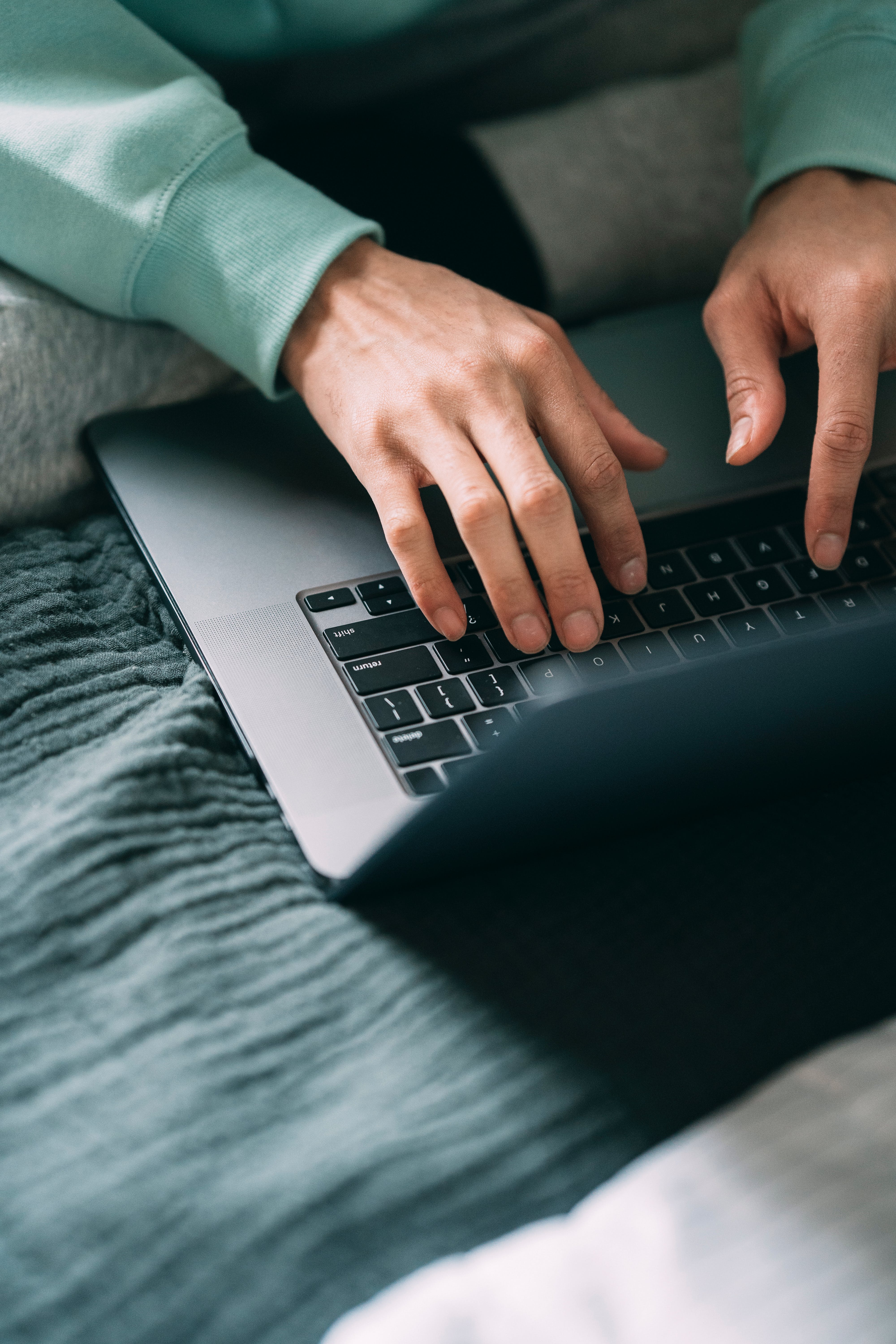 Two hands on a laptop keyboard